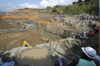 Excavators work to find 15 miners who were buried in a collapse near the town of Santander de Quilichao in Colombia as 1500 illegal miners look on.